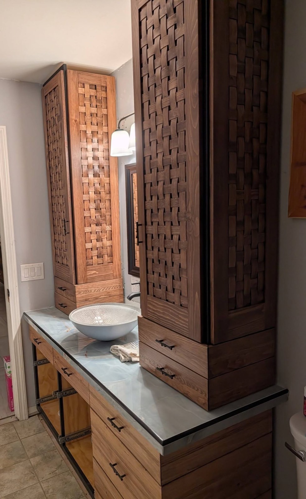 Custom vanity with woven-wood tower cabinets